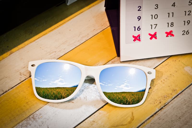 Eine Sonnenbrille und ein Terminkalender, was steht im Bundesurlaubsgesetz?